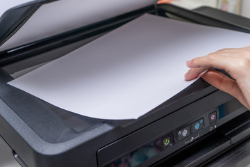 Close up Woman's hand with working copier, printer