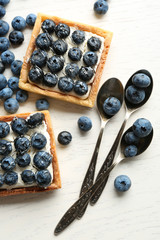 Gourmet fresh blueberry tarts on table