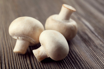 Champignon mushrooms on grey wooden background