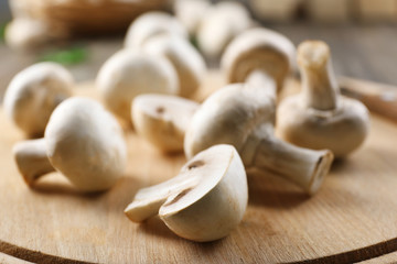 Champignon mushrooms on wooden background
