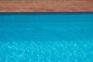 Fototapeta na wymiar Blue swimming pool - water ripples