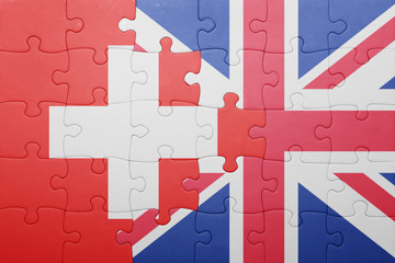 puzzle with the national flag of great britain and switzerland