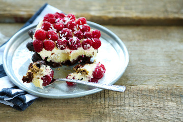 Sweet cake with raspberries on wooden table background