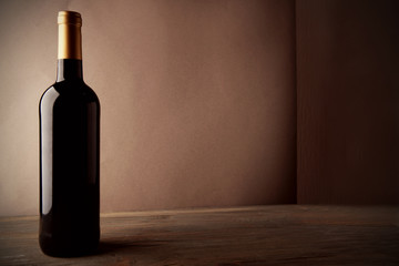 Bottle of red wine on wooden table