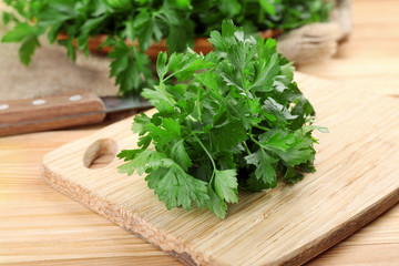 Fresh parsley on wooden cutting board
