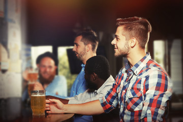 Young men drinking beer in pub