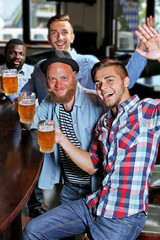 Young men drinking beer in pub