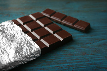 Dark Chocolate bar in foil  on gray background