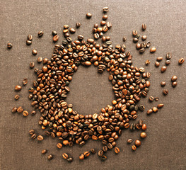 Roasted coffee beans on grey textile background
