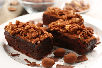 Pieces of chocolate cake with walnut on the table, close-up