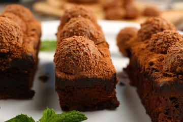 Pieces of chocolate cake with mint on the table, close-up
