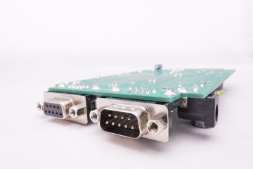 Serial port and green PCB circuit with white background