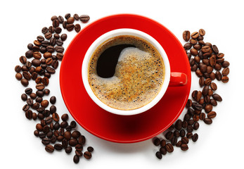 A red cup of tasty drink and scattered coffee grains, isolated on white, top view