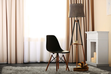 Stylish conception with chair and lamp on light room background