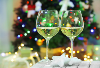 Two champagne glasses on christmas decor background