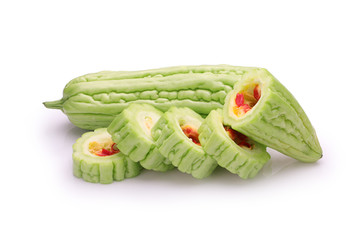 slices of bitter gourd arranged on white background
