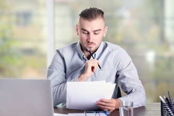 Businessman working with laptop in office