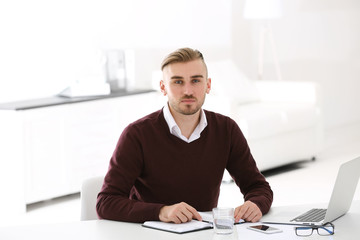 Businessman working with laptop in office