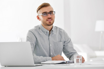Businessman working with laptop in office