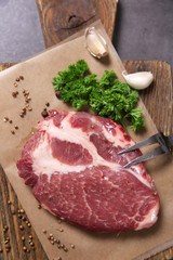 Marbled beef steak and spices on wooden background