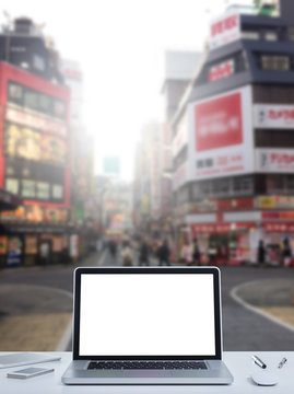Laptop computer with Shinjuku street background