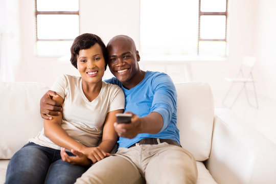 African Couple Watching Movie At Home