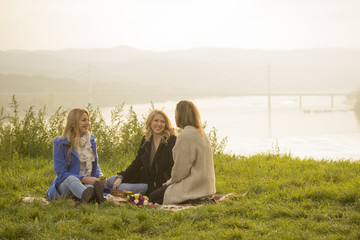 Three young girls, picnic in nature.