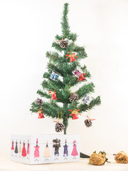 Christmas tree with gift present box on wooden table and white b