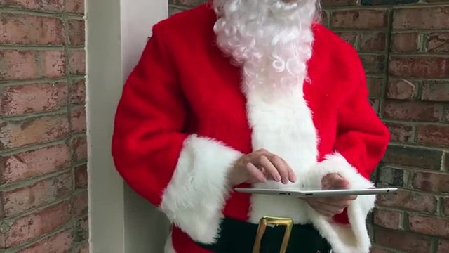 Santa Claus shopping online on a tablet