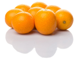 Fresh kumquat fruits over white background