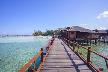 Naklejka premium beautiful floating chalet at mabul island aand blue sky
