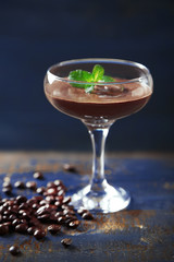 Chocolate dessert in glass on color wooden background
