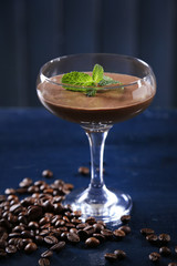 Chocolate dessert in glass on color wooden background