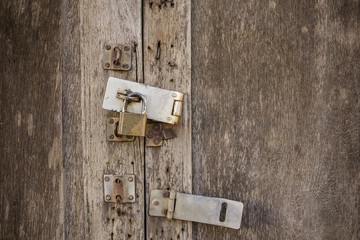 Old padlock on a wooden door - Golden Key lock