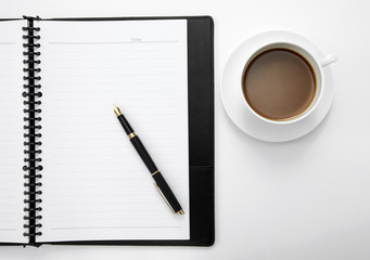 Notebook with a pen and a cup of coffee