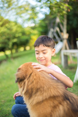 Little boy sitting with dog friendship