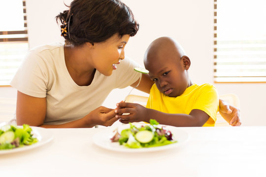 African Mother Asking Her Son To Eat Vegetables