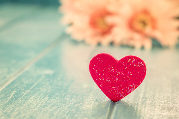 Naklejka na ściany i meble Love red heart on blue wooden table background