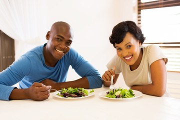 young african american couple eating healthy salad