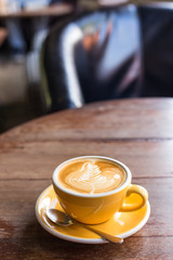 Hot art Latte Coffee in a cup on wooden table.