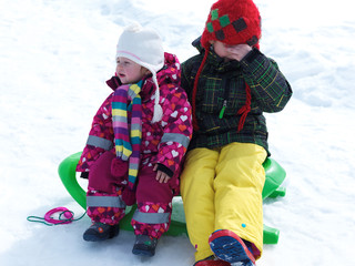 portrait of boy and baby girl on winter vacation