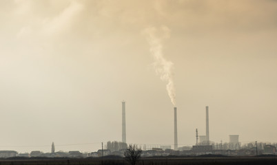 Fototapeta na wymiar Industrial cityscape with coal power plant and smoke stacks