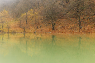 Reflection of autumn wood in lake.Village Vandam.Duyma.Gabala.Az