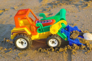 plastic toy truck on the sand
