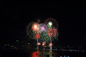 fireworks at the sea and city on background