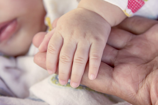 newborn baby hand on mother hand, holding hand with love