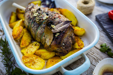 Lamb meat - roasted leg of lamb with rosemary, spices and roasted potatoes
