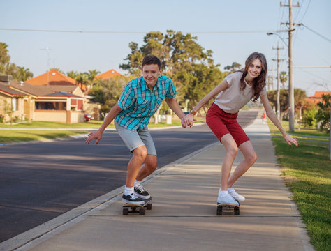 brother and sister with  skateboard