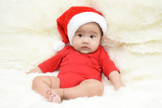 asian cute baby sitting on a soft cloth in the living room. Baby