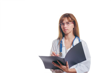 The serious woman the doctor in a white dressing gown with the black folder in a hand writes with the handle the clinical record
